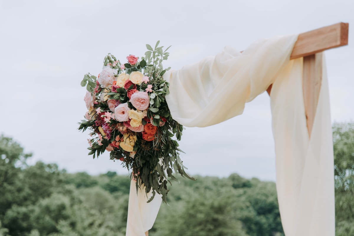 Elegant beach wedding setup with starfish runway and bamboo arch