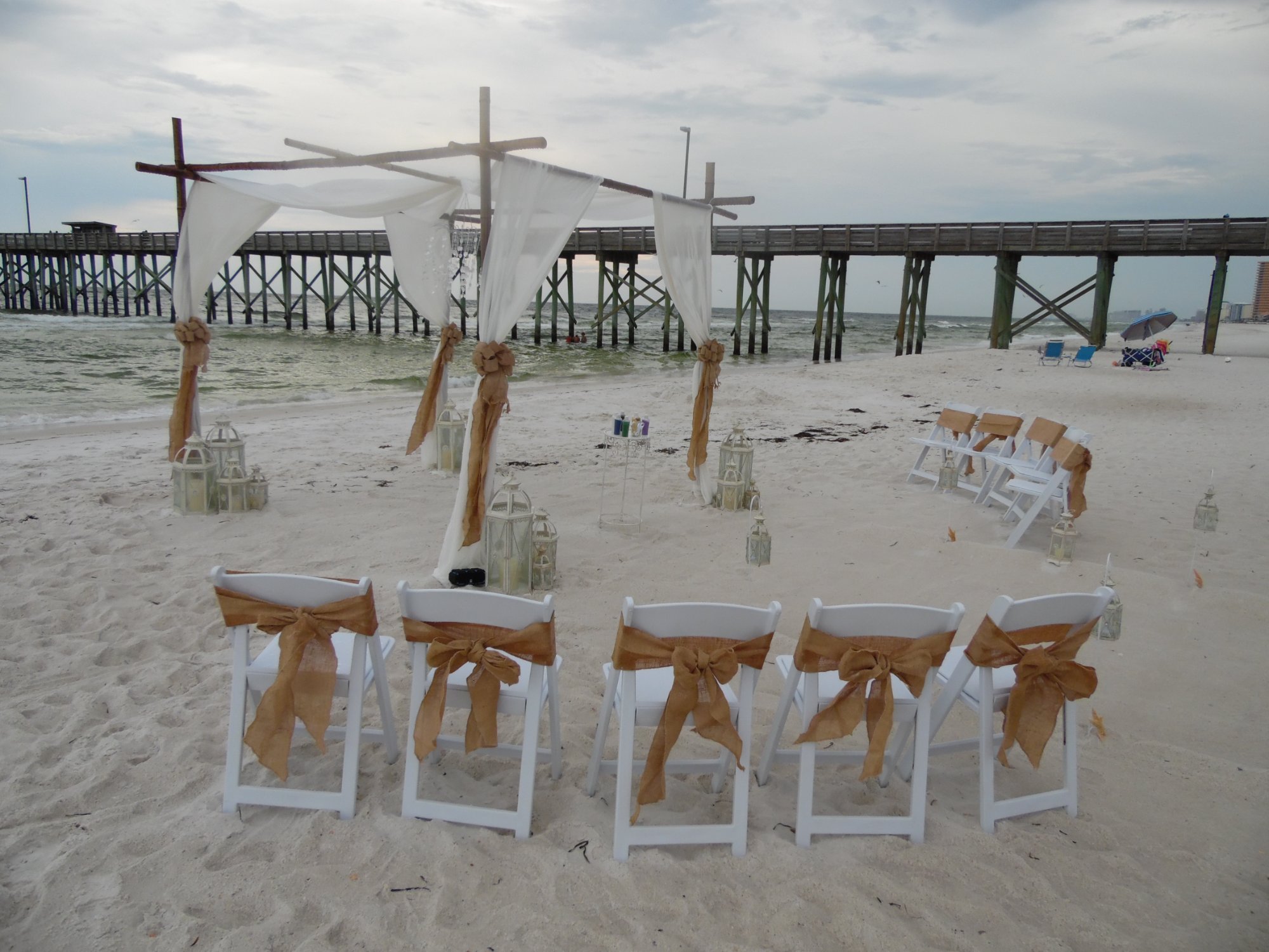 Burlap chairs at pier beach ceremony