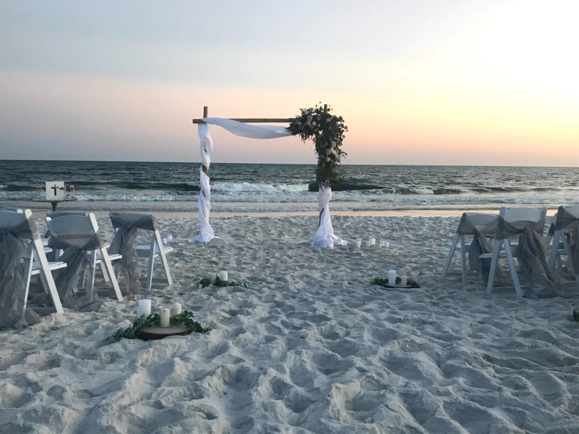 Grey sash chairs at sunset ceremony