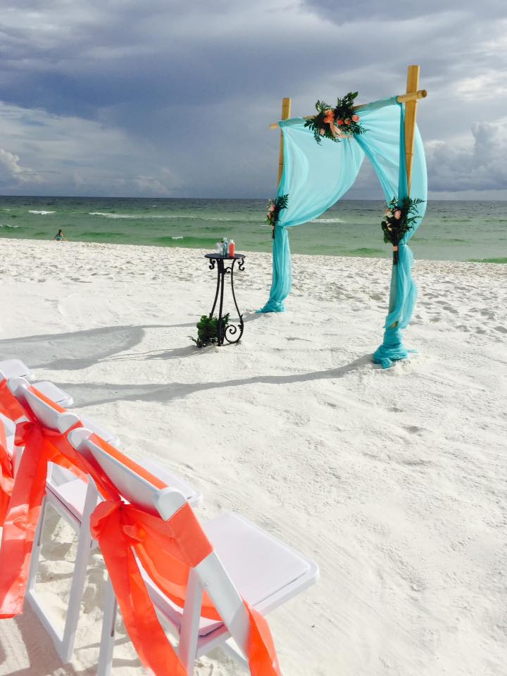 Teal sashes on white chairs at ceremony